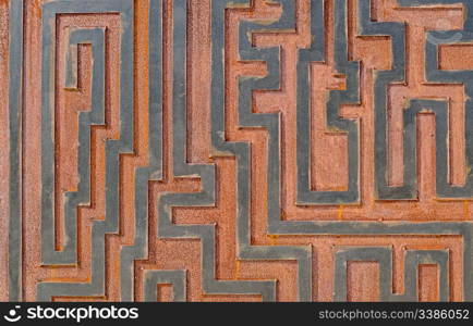 Metal rusty background, with geometrical shapes forming a labyrinth.