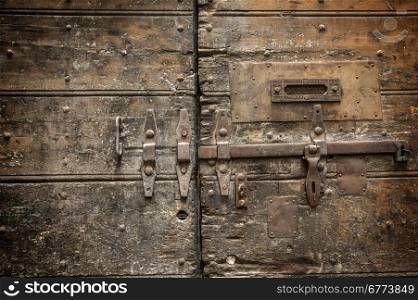 Metal rusty door handle on wood background