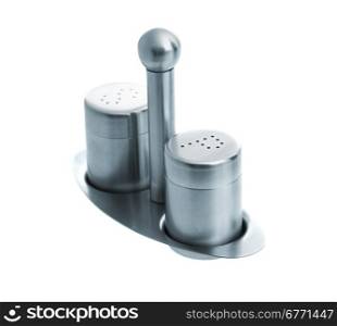 Metal salt and pepper shakers on stand and isolated on white background, studio shot, two objects, upper angle