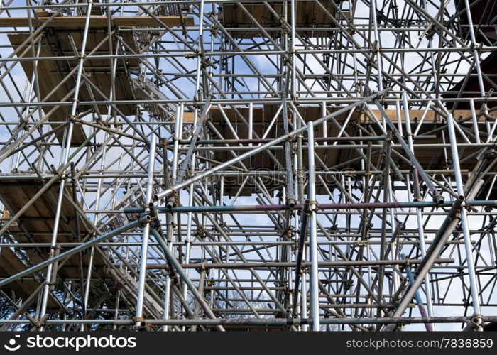 Metal scaffold and woden platforms on construction site