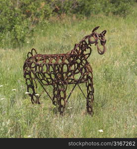 Metal sculpture of an animal in field