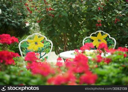 metal seat chair in flower garden park in spring summer