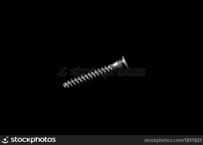 metal self-tapping screw on black isolated background
