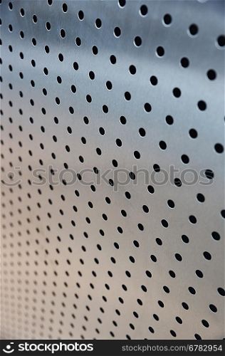 metal sheet with holes, closeup photo
