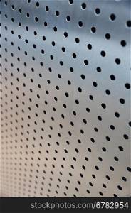 metal sheet with holes, closeup photo