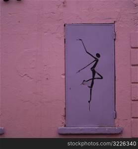 Metal shutter with a human figure on a wall