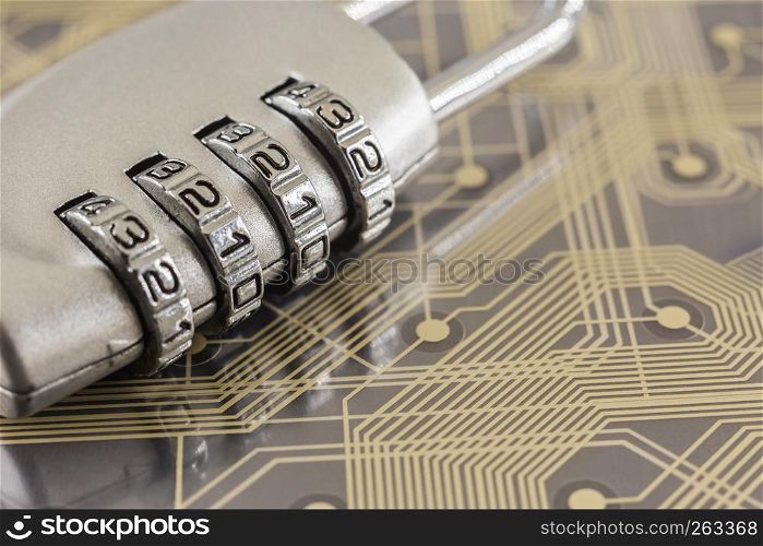Metal silver padlock with 4 digit combination lock put on plastic digital circuit board, gold line background. Electronic data, cyber security and information privacy concepts.