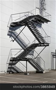 Metal staircase on fire exit at big factory