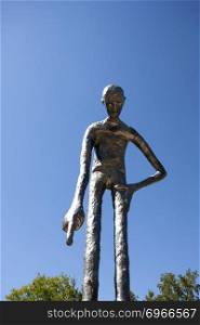 Metal Statue in Elora Ontario man standing blue sky