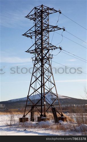 Metal support power lines against the blue sky. Russia. Monchegorsk.