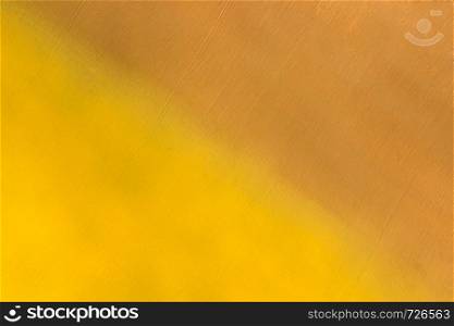 metal surface painted in yellow and brown color diagonally, background or texture