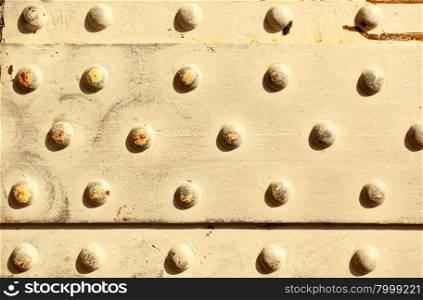 Metal surface with rivets, may be used as background