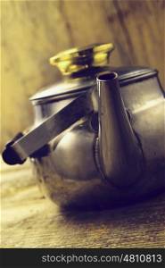 metal tea kettle on wooden background
