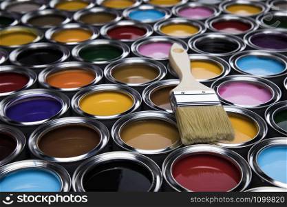 Metal tin cans with color paint and paintbrush