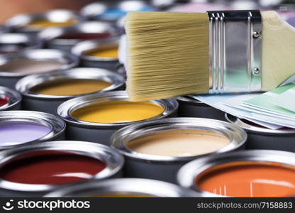 Metal tin cans with color paint and paintbrush