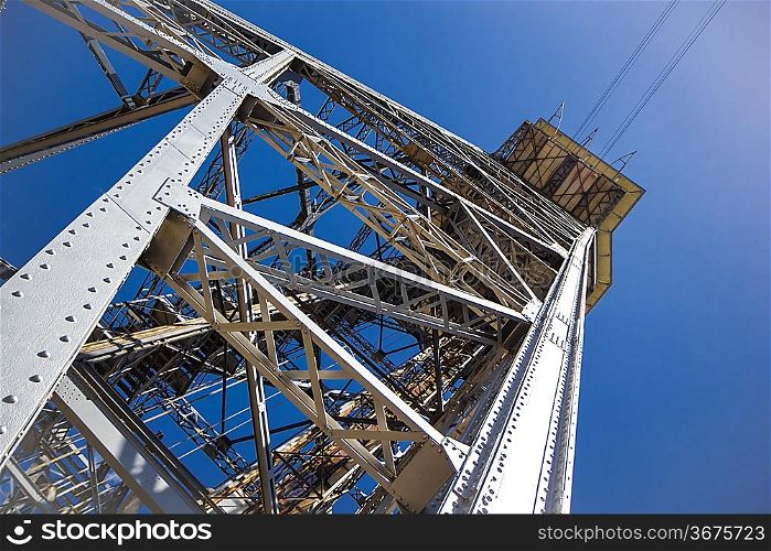 Metal tower on blue sky background. Photo.