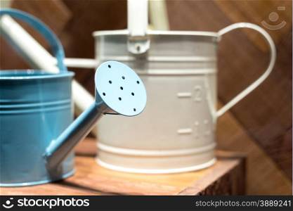 Metal Watering Cans in Wooden Shed