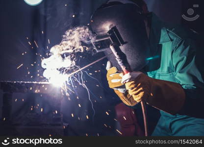 Metal welding steel works using electric arc welding machine to weld steel at factory. Metalwork manufacturing and construction maintenance service by manual skill labor concept.