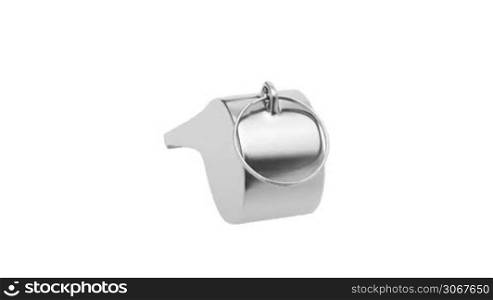Metal whistle rotates on white background