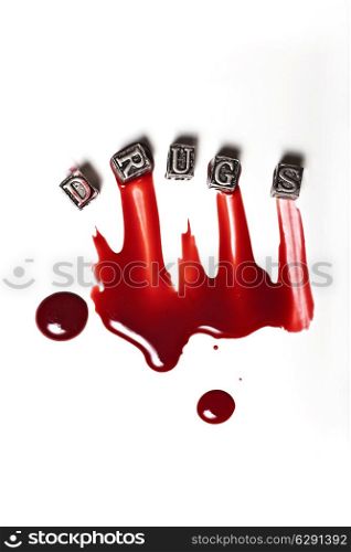 Metal Word drugs in drops of blood on white background