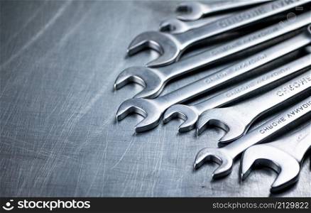Metal wrench on the table. On a gray background. High quality photo. Metal wrench on the table.