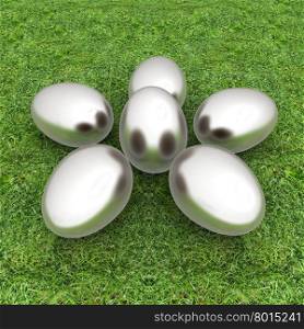 Metall Easter eggs as a flower on a green grass
