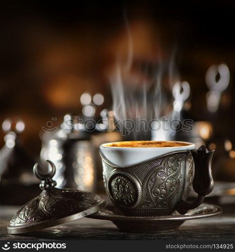 Metallic coffee set in turkish style on wooden table