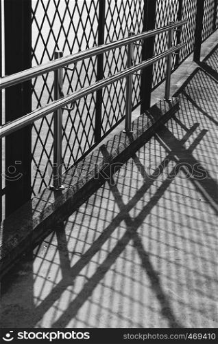 metallic fence shadow abstract silhouette on the ground