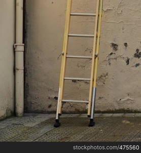 metallic ladder on the wall in the street