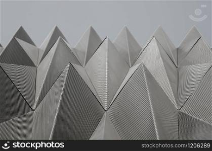 Metallic piramids make the faces of the Navarrabiomed building near the hospital of Pamplona, Navarra, Spain. Metallic piramidal pattern in the Navarrabiomed building in Pamp