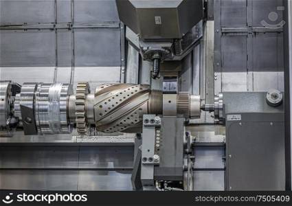 Metalworking CNC lathe milling machine. Cutting metal modern processing technology. Milling is the process of machining using rotary cutters to remove material by advancing a cutter into a workpiece.
