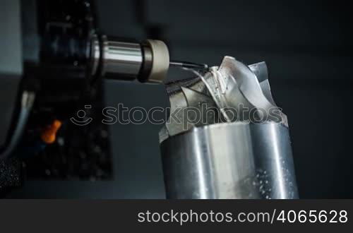 Metalworking CNC milling machine. Cutting metal modern processing technology. Small depth of field. Warning - authentic shooting in challenging conditions. A little bit grain and maybe blurred.