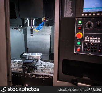 Metalworking CNC milling machine. Cutting metal modern processing technology. Small depth of field. Warning - authentic shooting in challenging conditions. A little bit grain and maybe blurred.