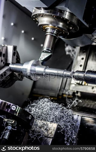 Metalworking CNC milling machine. Cutting metal modern processing technology. Small depth of field. Warning - authentic shooting in challenging conditions. A little bit grain and maybe blurred.