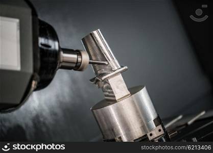 Metalworking CNC milling machine. Cutting metal modern processing technology. Small depth of field. Warning - authentic shooting in challenging conditions. A little bit grain and maybe blurred.