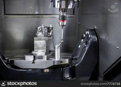 Metalworking CNC milling machine. Cutting metal modern processing technology. Small depth of field. Warning - authentic shooting in challenging conditions. A little bit grain and maybe blurred.