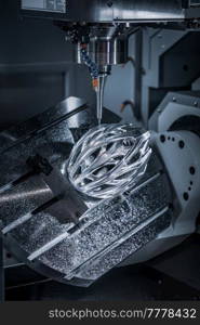 Metalworking CNC milling machine. Cutting metal modern processing technology. Small depth of field. Warning - authentic shooting in challenging conditions. A little bit grain and maybe blurred.