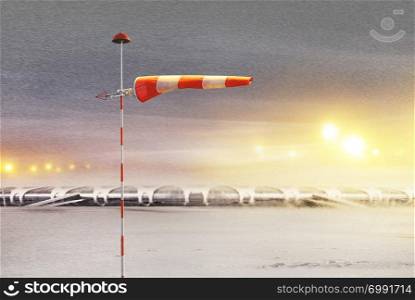 Meteorology windsock inflated by wind in airport at not flying night