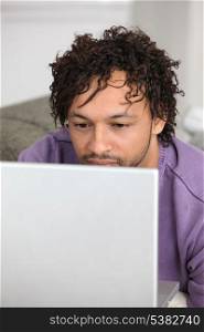 Metis man using laptop at home