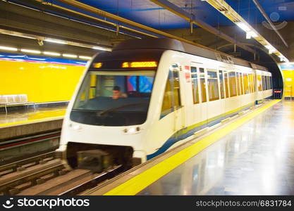 Metro train arrives at underground station. Madrid, Spain