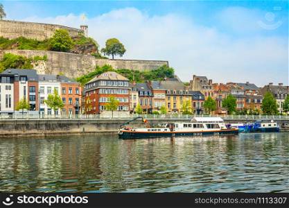 Meuse river with passenger boats and Citadel of Namur fortress on the hill, Namur, Wallonia, Belgium