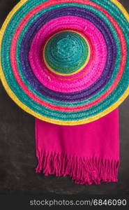 Mexican background. Sombrero and blankets on rustic slate background. Top view with copy space