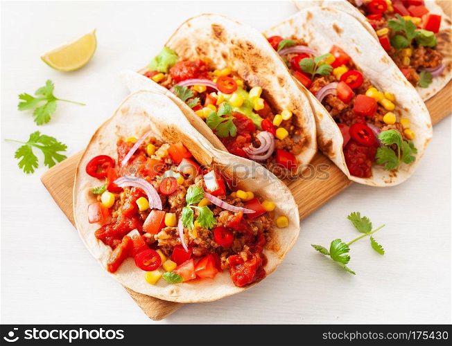 mexican beef and pork tacos with salsa, guacamole and vegetables
