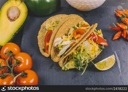 mexican beef tacos with vegetables tomato avocado black slate