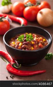 mexican chili con carne in black bowl with ingredients