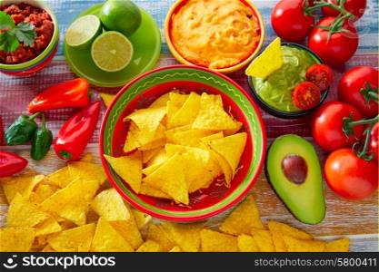 Mexican food nachos and guacamole with chili peppers and sauces