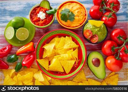 Mexican food nachos and guacamole with chili peppers and sauces