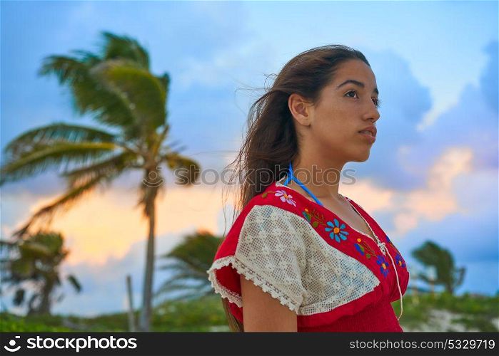 Mexican girl embrodery dress at sunset in Caribbean palm trees