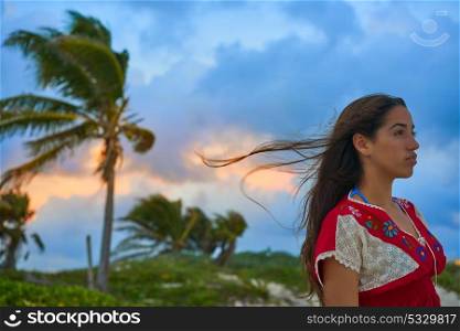 Mexican girl embrodery dress at sunset in Caribbean palm trees