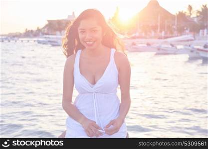 Mexican latin woman smiling at Caribbean sea of Riviera Maya in Mexico